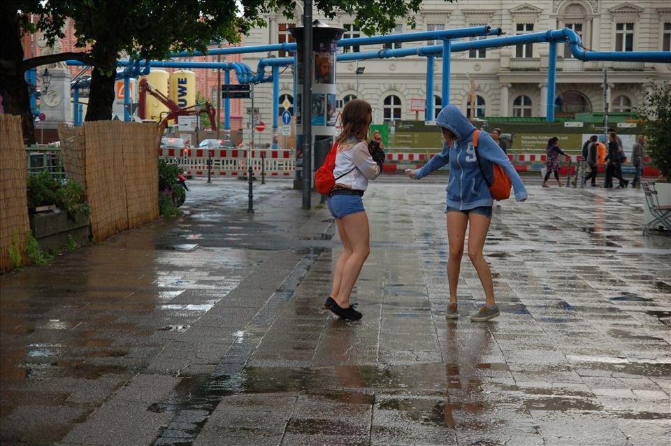 There wasn't a soul in the streets because there was an important football match. It had started raining, these two were dancing under the rain.