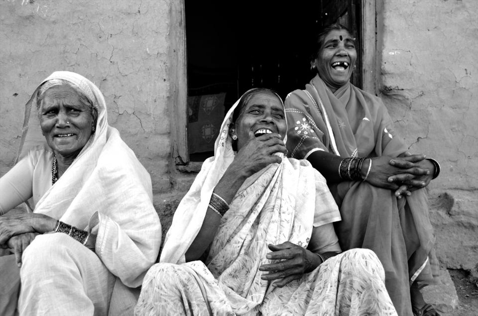 Neighbours enjoy each other's company, while sitting outside one of their mud-fabricated houses in Asade village. Baibai, on the left side, has been elected as the head of her community, despite belonging to the lowest caste.