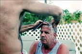Ronaldo is a Hairdresser, he works in the 5 star hotel on the island. Here he is routinely cutting Mikes hair in their back garden. : by clarahooper, Views[557]