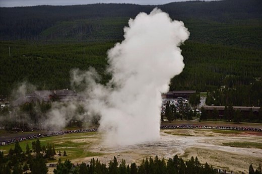 Old Faithful Geyser erupting at Yellowstone (look at the crowd of people!)
