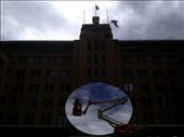 (4) Anish Kapoor is one of the most recognisable contemporary artists in the world today.  The Museum of Contemporary Art is 
featuring some of his works for the first time in the gallery. This photograph looks not only at Kapoor’s 
reflective work ‘The Sydney Eye’, it also looks at what an object is, in relation to other things. In this case, Kapoor’s circular work reflecting the sky around Sydney, is juxtaposed against the solid square matt mass of the museum itself.  It is fitting because Kapoor’s work looks at ideas of form, voids and content, and how an object can be and not be. I was particularly pleased to catch this 
moment of two workers shining the great reflective surface, preparing the work for the public gaze, themselves becoming a piece of art in my photograph. (This photo was taken with an iPhone)
: by clarebardsleysmith, Views[619]