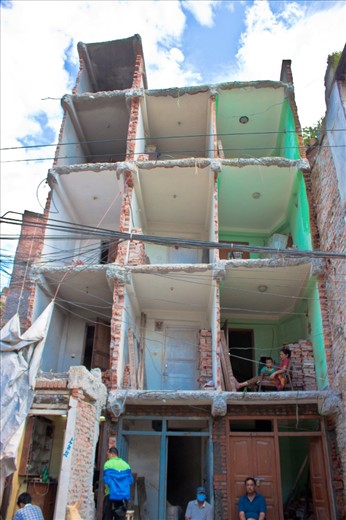 This photo is of a house that has lost about half of its front. I thought it was a great subject cause it shows a lady and her child in one of the rooms. It also shows whats really happening. There goes your privacy out of the window