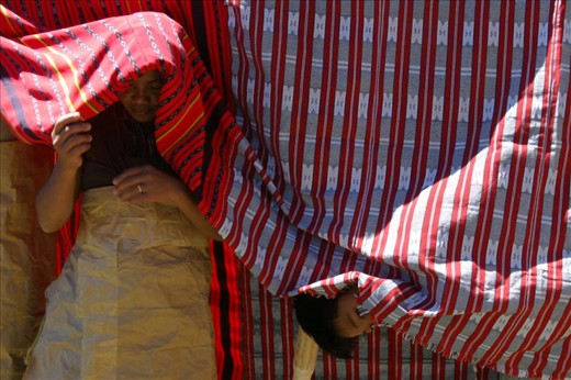  A woman and a young boy took refuge in locally made fabric to hide from the sun.