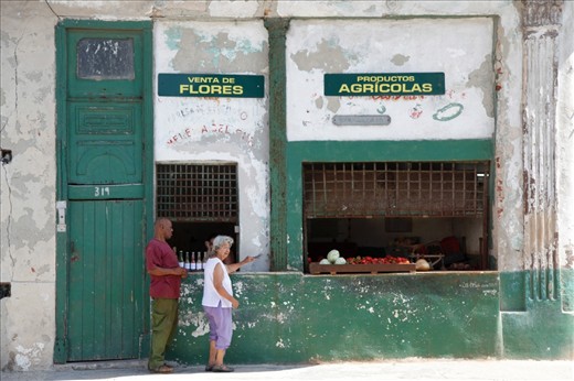 Havana, Cuba. People are chitchatting at the produce store. Since the country does not import any of its produce, the availability varies according to what is in season.