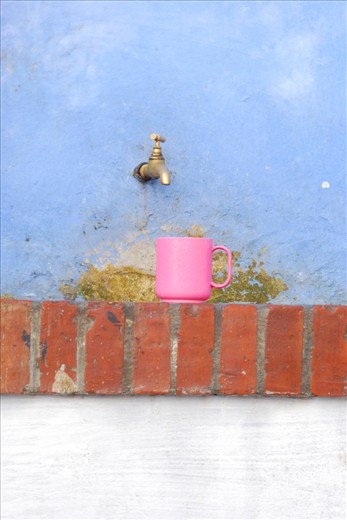 Scattered all over the streets of Chauoen are a number of drinking fountains used to cool off from the heat of the day, or to grab water for the days activities. I stumbled over a couple of them that had a cup placed on the wall waiting to be used. Obviously left there for whoever needs to quench there thirst next.

I did not move the beaker, it is exactly as found. I couldn’t resist the colour of the pink against the blue wall.