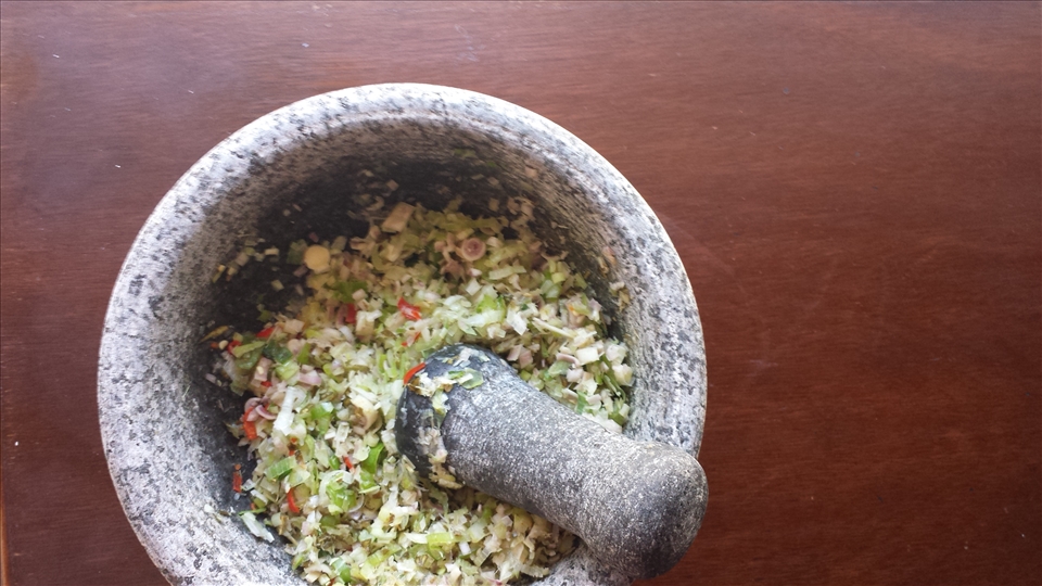 Pounding in the mortar and pestle, old fashioned way
