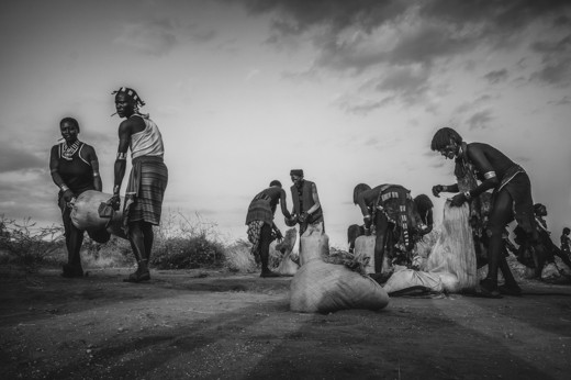 Turmi, Omo Valley, Ethiopia. Work is done at sunset, when it's cooler, but there is still some light.
