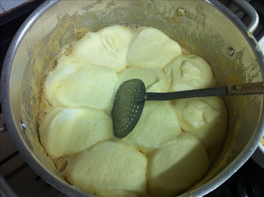 Sweet milk's surface full of little egg clouds.