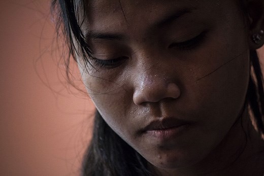 A young teen gathers herself after a harsh practice of traditional dance