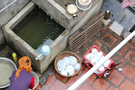 Not so many people left still using rain water to clean the dishes like this lady.