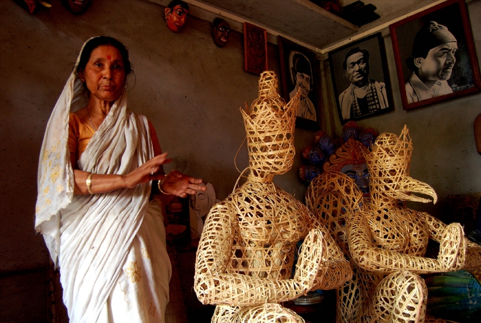 A lady with the treditionaly making mask here in Samguri satra.Majuli is the home of world famous Indian mask craft, which is used in the age old traditional Assamese theatre known locally as “Bhaona”. The traditional Assamese masks are made from a variety of materials, ranging from terracotta and bamboo to wood, pith and metals. They usually represent the local gods and goddesses, characters of ancient epics like the Mahabharata or historical figures.

The size of Assamese masks may vary from those that cover the whole body to the ones that only cover the face. Depending on the size, these masks are divided into three types - Cho mask, Lotokoi mask and Mukh mask. Cho mask is the biggest in size and usually made of two parts - head and body. Lotokoi mask is a smaller version of the Cho mask and the Mukh mask only covers the face. The traditional Mask making process started in Majuli during the mid of 17th century.