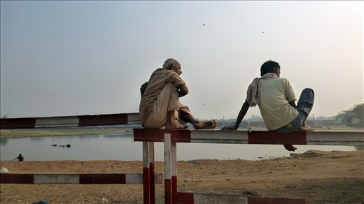 Captured from the window of my taxi. Just outside the chaotic streets of New Delhi, two locals find time for a quick break.