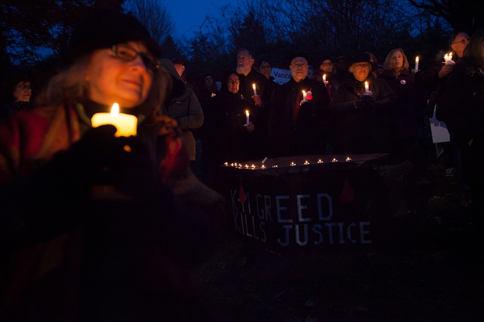 Over 500 supporters rallied against Kinder Morgan on this night. Many people were holding candles, and most dressed in black. This was done to mourn the death of the justice system, because the supreme court ordered an injunction that the protestors had to allow Kinder Morgan to work. The background people are standing above a coffin. 