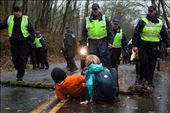 After the injunction was granted, protestors did whatever they could to prevent Kinder Morgan from working. In this image, two protestors lay on the ground in front of a log they placed on the road to prevent the Kinder Morgan work truck behind the police from getting up the road. So far, over 30 people have been arrested from crossing the injunction line. The fight continues... : by connorstefanison, Views[263]