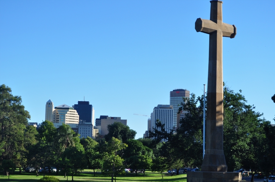 Religion vs Corporate World. A sign of cross magnificently looking at the backdrop of themodern corporate world.(Adelaide)