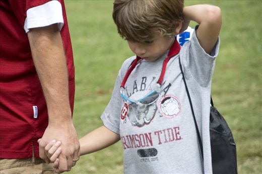 A child was cold and needed her mom to rub her feet and put her socks on. 
