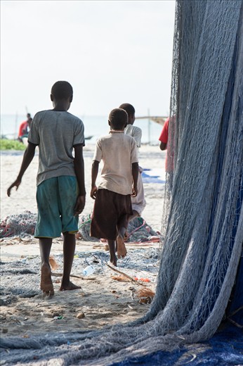 The younger boys finish hanging the nets out to dry.