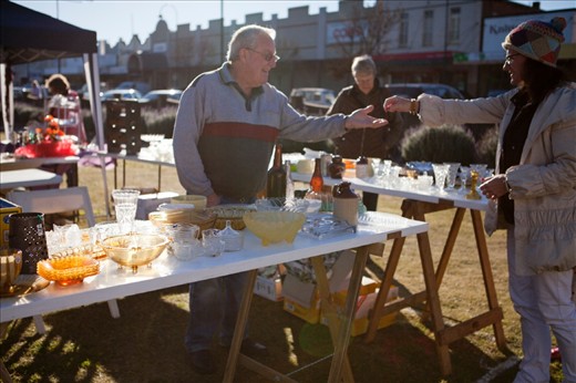 He has gotten up early for these markets, the opportunity to sell his second hand treasures. One buyer spots something she likes and willingly hands over tender. He is grateful for the business.