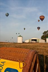 Every year over a hundred hot air balloons compete for ten days at the National Balloon Classic in Indianola, Iowa, USA. A balloon’s basket lies on its side, awaiting launch, while the pilot (shadow on right) watches the other balloons to gauge that morning’s winds.: by cracibo, Views[340]