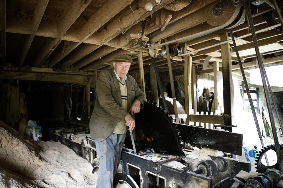 Aidan Murphy (miller and sawyer) is standing beside the huge circular saw used for cutting timber for roofing houses. The mill and saw were built in the late 1700's and is still being completley operated by water to this day which has been channeled from the river Urrin. Local farmers would bring there grain by horse and cart in sacks weighing 17 or 18 stone. The grain would be ground by french burr stones into flour and oat meal. During the emergency in 1939 -1946, (World War II) each member of the house hold was entitled to1 barrel (20 stone, 125kg) of wheat meal per annum, ½ oz tea and 1lb sugar per week. 