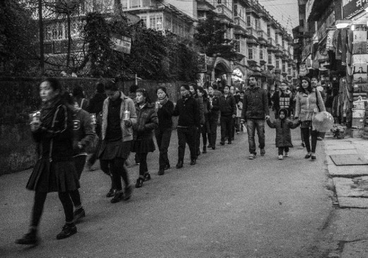 students taking part in the SAVE TIBET peace march at chaurasta, darjeeling. the rally was to downtown darjeeling and back. locals were observing from the other half of the road.