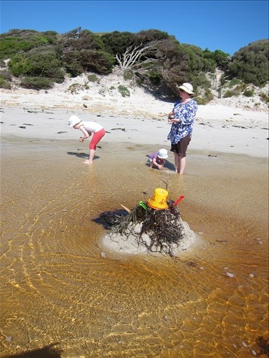And the tide comes in and joins with little creek... And before too long the sand monster is consumed by the water