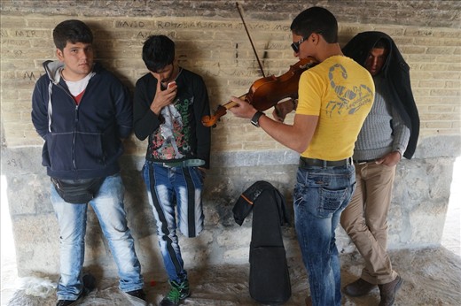 Under a historic bridge in the ancient city of Isfahan, a group of music enthusiasts enjoys the melodies emerging from a violin. In the Islamic republic, the ban on alcohol and the enforced separation of unrelated men and women uniquely shape the leisure time the youths spend during their Nowruz holidays. 