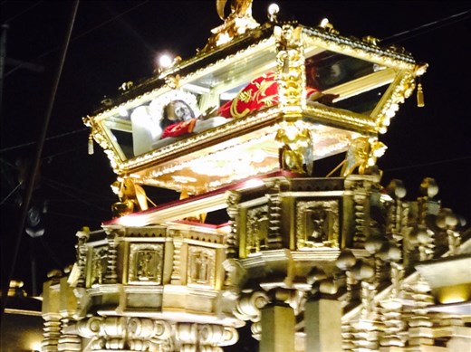 Christ dead body in a red robe inside gold tomb. 