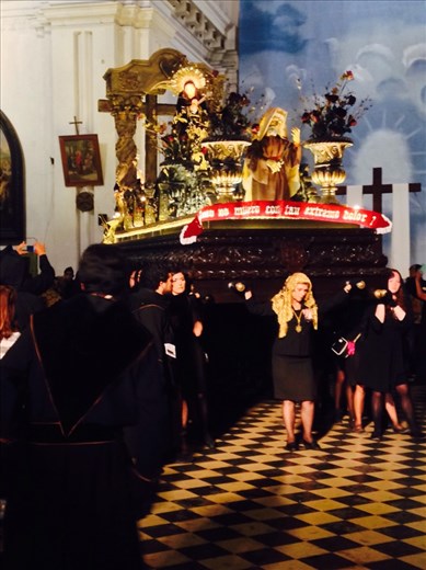 Women carrying the anda of the grieving Virgin Msry.. The body of the dead Christ has just left the church.  