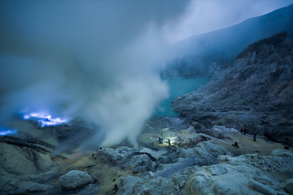 Down the crater of Mt Ijen. Blue flames constantly burn, sulphuric gas engulfs the miners.