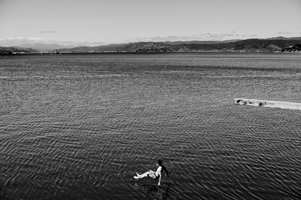 A swimmer appears to hover on the water after leaping into Wellington Harbour. Wellingtonians have a love affair with the ocean, a surrounding playground of life and enjoyment. November 2010.