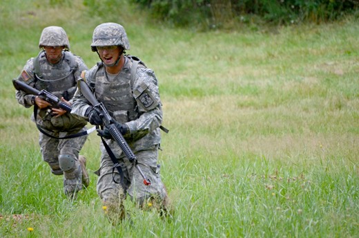 Alpha team Cadets lead their team across a field at the live fire combat training course. Cadets are expected to move as if they are on the front lines of combat. That means running low, diving and rolling their way across open areas. 