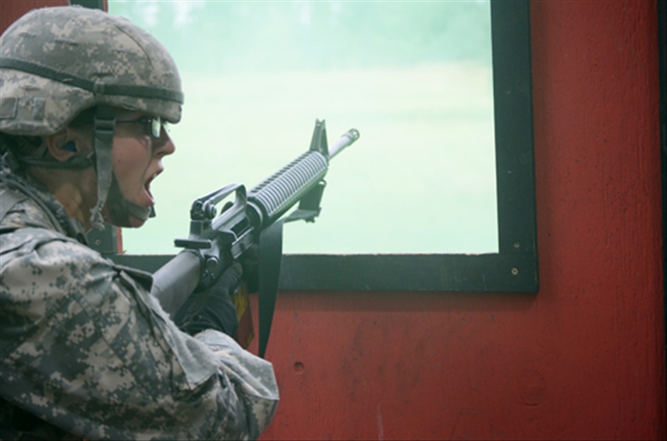 A Cadet calls for cover after running out of ammo during a combat simulation. Cadets use live ammo during these simulations and are expected to reload or fix a jammed weapon under pressure. 
