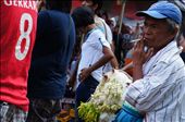 The smoke rising in languid curls into the air keeping him company, a Sampaguita (Jasmine flower) vendor battles fatigue with a stick of cigarrette while he waits at the back of the crowd for the chruchgoers to disperse. Most Filipinos treat their religious statues as human, which is believed to bring the owners luck: dressing them in elaborate clothing and sometimes offering food. Sampaguita necklaces are used to adorn religious statues' necks. : by cysabela, Views[646]