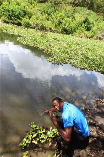 Erick, my guide, collects a water sample for me.