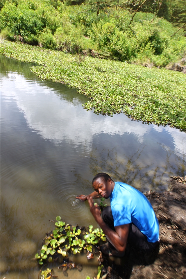 Erick, my guide, collects a water sample for me.
