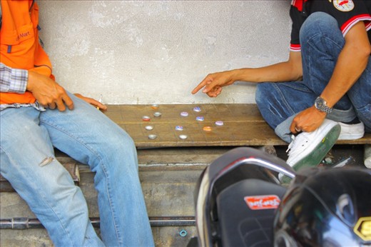 Another moment of a break during work. I loved how these man made a game using bottle caps