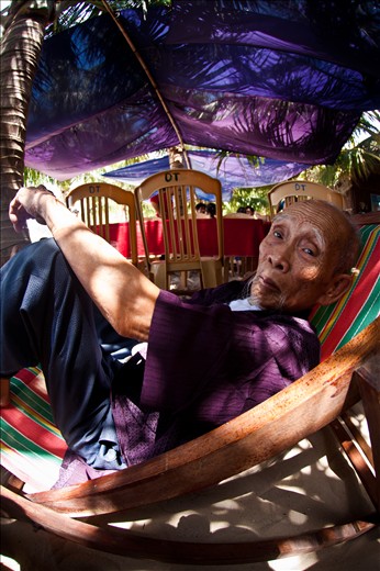 Escaping from the heat, an elderly man holds the secrets to an exultant life.