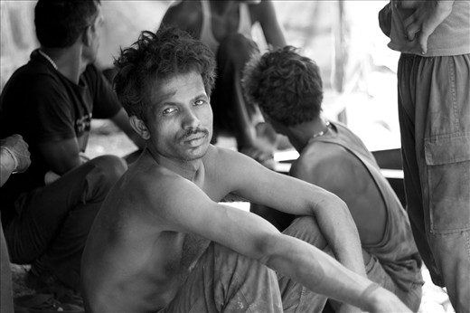 Meet Tribhuvan, a labourer who has been laying down roads for the past 15 years. He, along with his friends has spent almost half of their lives on the road. With no other place to go, they have now accepted the road as their only abode.

Working in the scorching heat of 44 degrees at the walled city, it becomes almost impossible to walk, let alone work. But these unsung architects fiddle with the tar, dust and gravel like a little kid who toys with clay. 
Here, Tribhuvan looks on with hope, while his co-workers engage in deep conversation.
