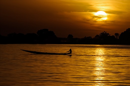 Fisherman returning home, racing with the sun, will he return home before the dark?
