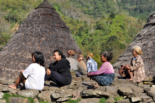 SUN BATH – It is customary that elderly people in Wae Rebo warm themselves up by sitting on stones in the morning sun.