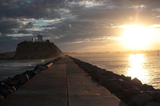 a shot taken along the breakwall showing the sun on one side leaving the left in shadow making the path appear to be a line between two worlds.  Canon EOS 600D EF-S 18-55mm 1/4000, f/5.0, ISO800. untouched.