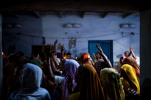 Women sing and dance in a local temple to celebrate Holi