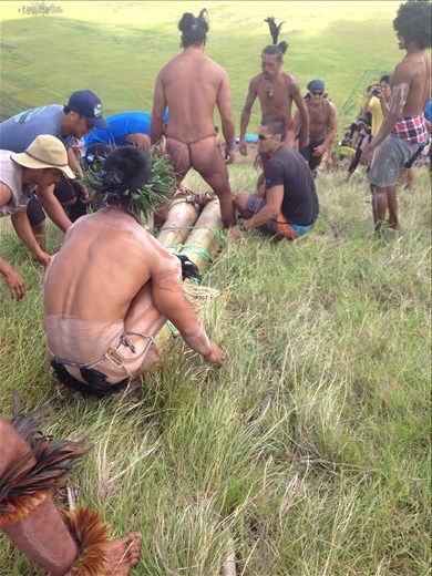 Mounting the two trees lashed together with rope. At this point there seemed to be a lot of praying going on. 