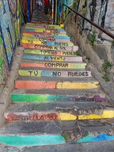 This set of stairs has lyrics to a song that go way back to when wealthy immigrants came to Valparaiso and bought up all the land leaving the locals with nothing. The songs says:
You cannot buy the wind, you cannot buy the sun and  you cannot buy the rain. 

