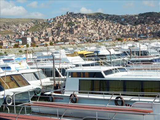 Leaving City of Puno by boat to visit the Uros floating reed islands on Lake Titicaca. 