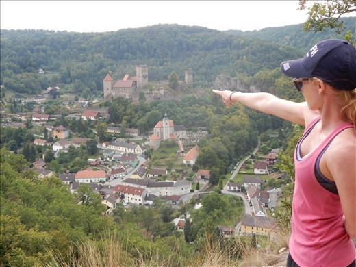 The town of Hardegg Austria and Danielle pointing at either where we are going for lunch or the very steep road we will have to climb out of town. 