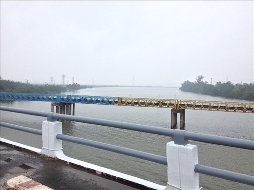 Crossing the 17th parallel or the border between north and south Vietnam. Apparently the battle between the two regions is painting the bridge at night to further expand the border in their favor. 