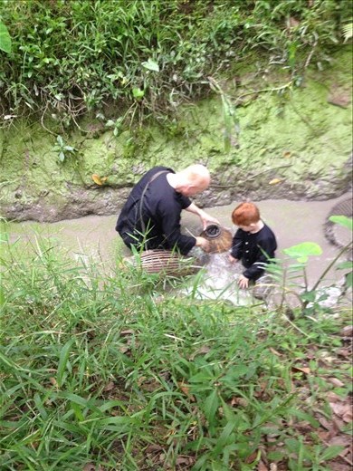Watching some boys and their dad catch catfish. 