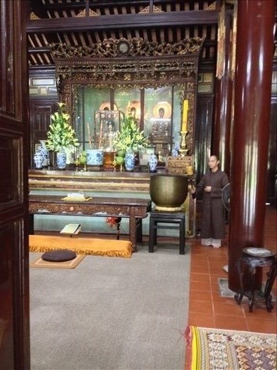 A monk sounding the gong. 